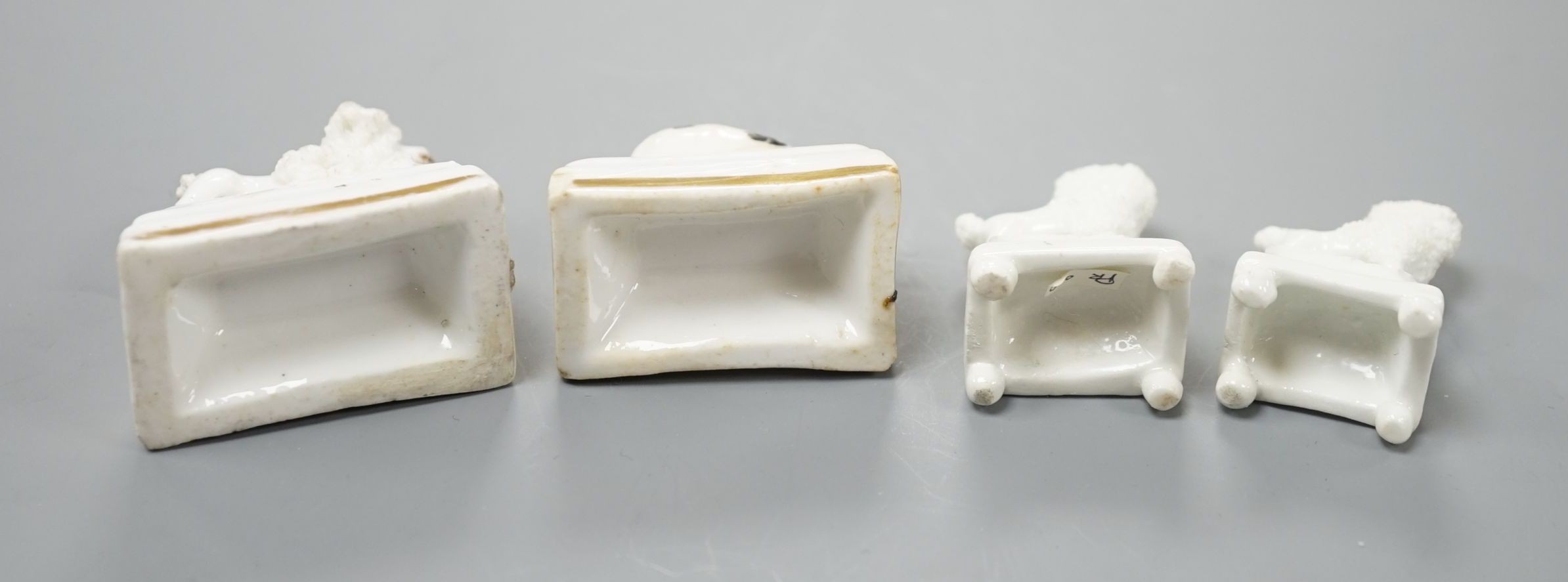 Four Staffordshire porcelain toy models of poodles and a King Charles spaniel puppy, c.1835-50, tallest 3.5 cm, Cf. Dennis G.Rice Dogs in English porcelain, colour plate 154., Provenance: Dennis G.Rice collection